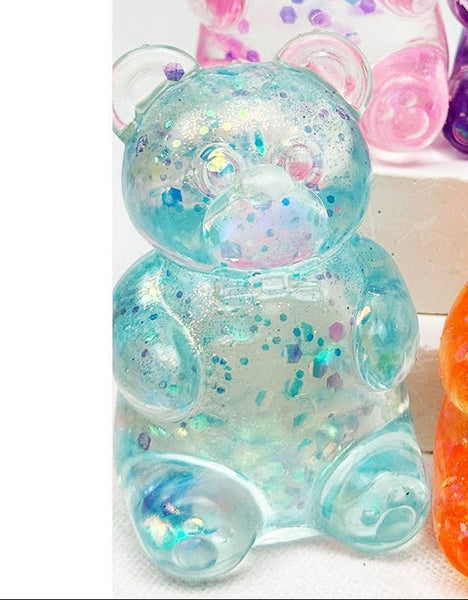 A colorful gummy bear toys in blue on a white background.